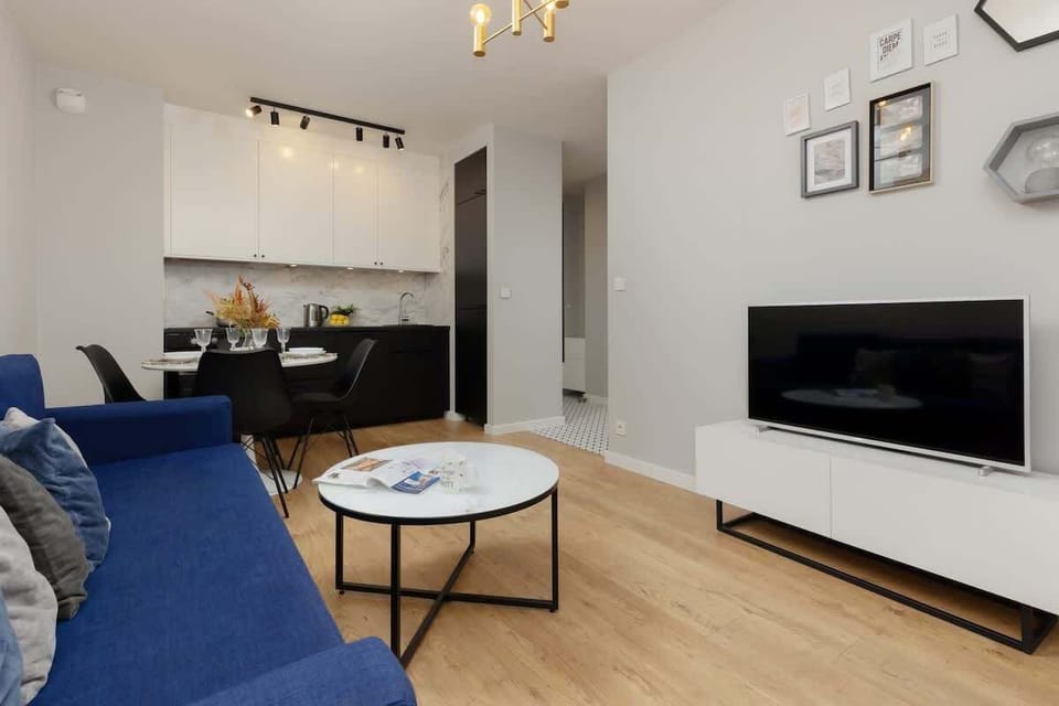 A modern living space showcasing a sleek TV, accent pieces, and a welcoming atmosphere.

