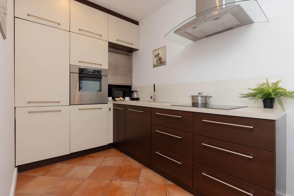 A sleek, fully equipped kitchen with modern cabinets, ample counter space, and high-end appliances.

