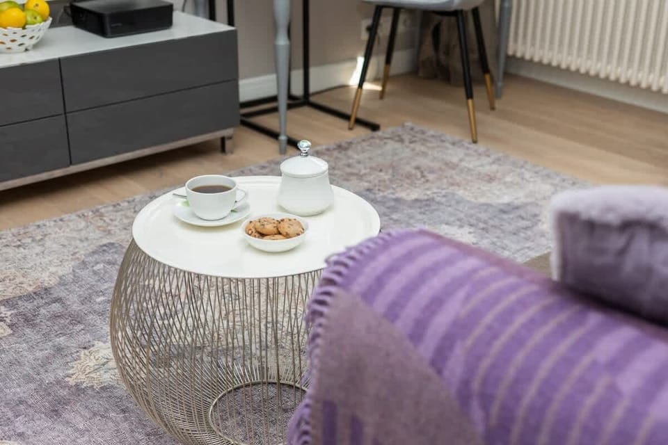 A bright and open dining area with a coffee table and elegant chairs, ideal for enjoying meals or working.

