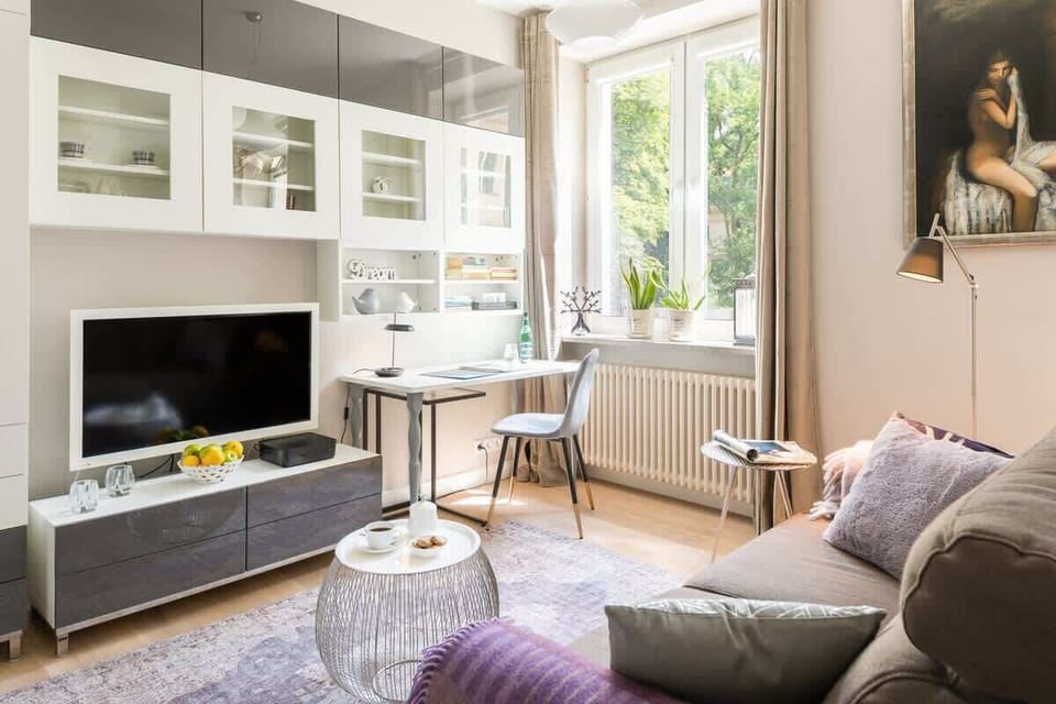 The living room from a different perspective, emphasizing its inviting seating area and modern entertainment unit.

