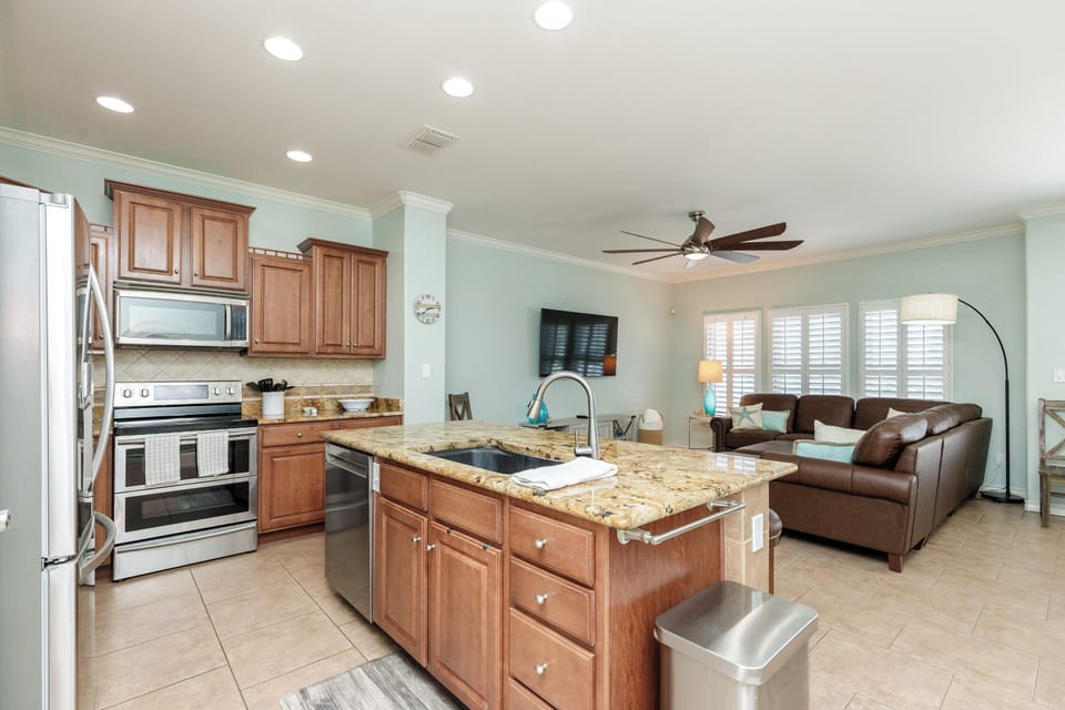 Your open-concept kitchen flows seamlessly into the living space, where granite countertops and modern appliances make meal prep a breeze.