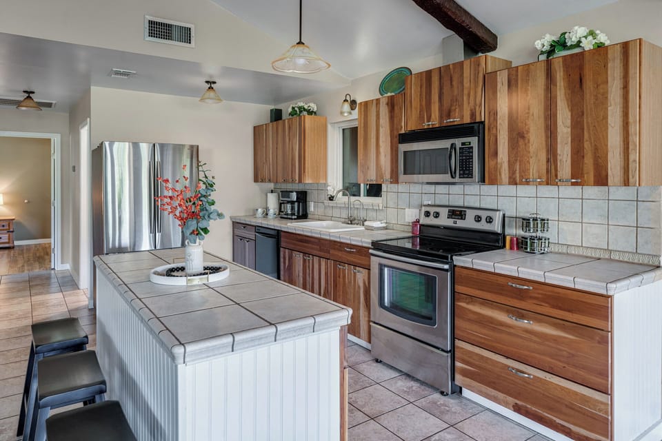 The kitchen is fully stocked with stainless steel appliances