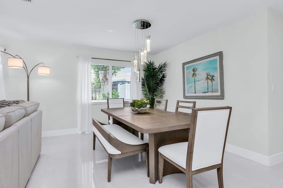 The dining area features a 6-person dining table perfect for your group feasts. There are 4 additional counter stools at the impressive quartz waterfall island.