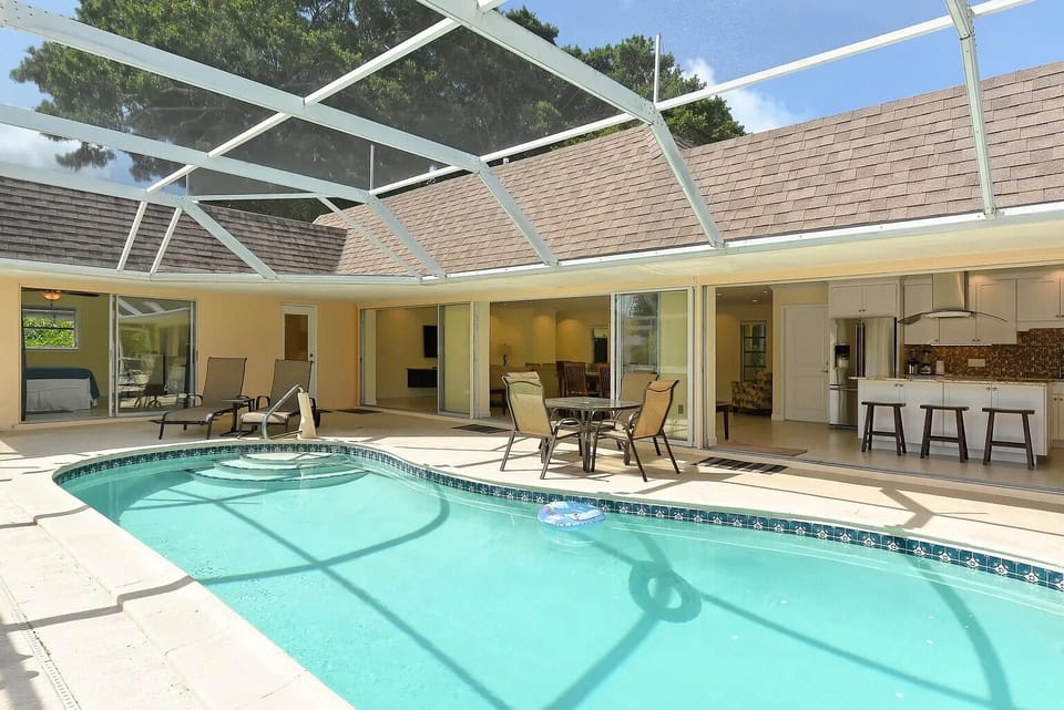 Private heated pool with deck chairs and loungers