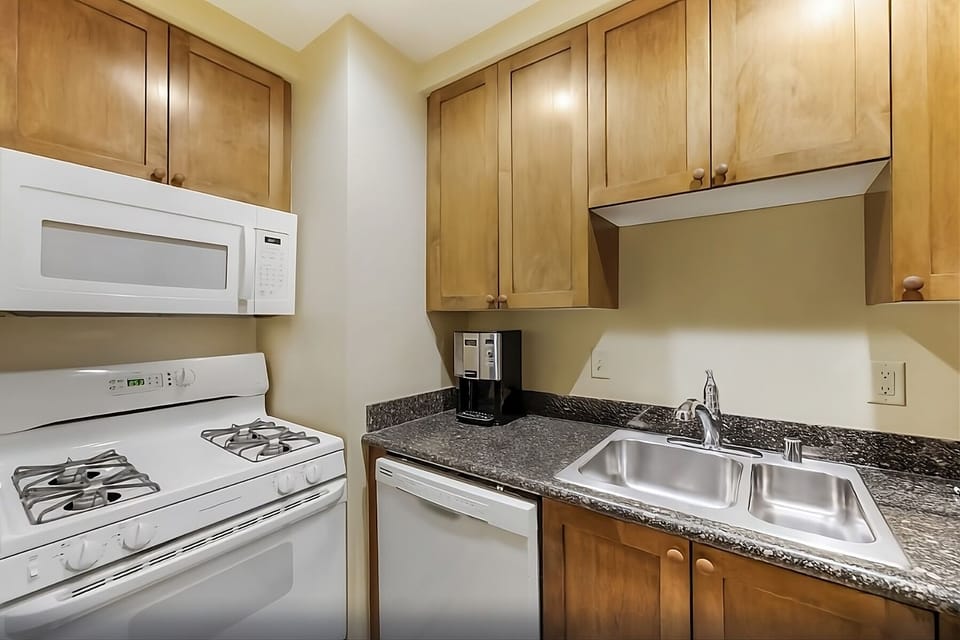 Cook quick favorites with full stove, microwave, and sleek counters.