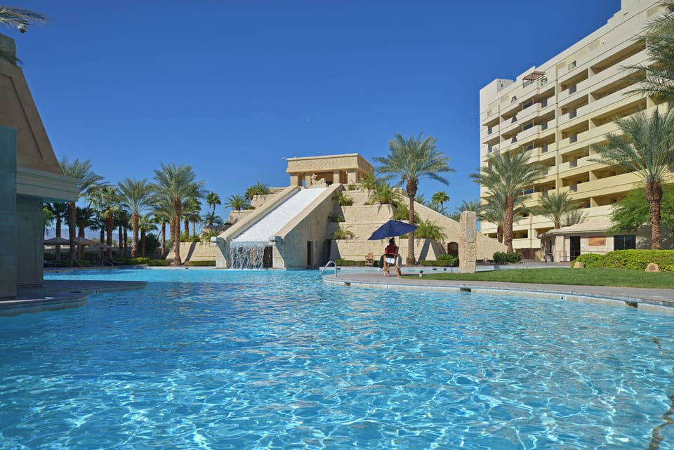 Dive into sparkling waters framed by palms and open skies.