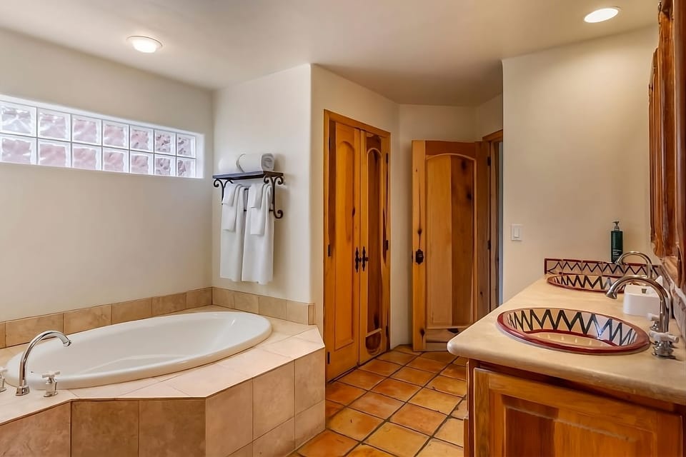 Soak and refresh in a deep tub with bright vanity space