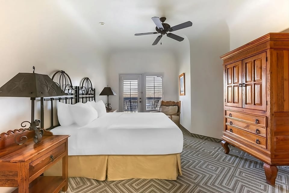 Unwind in a spacious bedroom with balcony doors and cool airflow