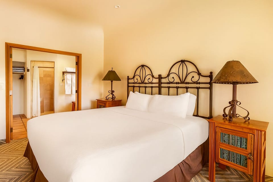 Relax into plush bedding with warm lamps and calming desert tones