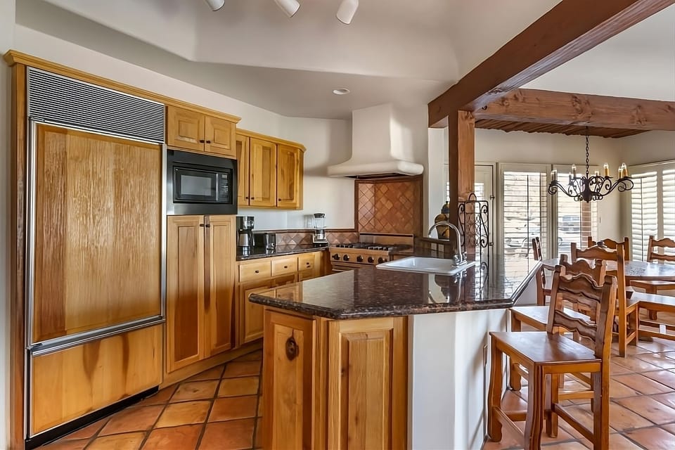 Gather around the granite island for easy meals together.