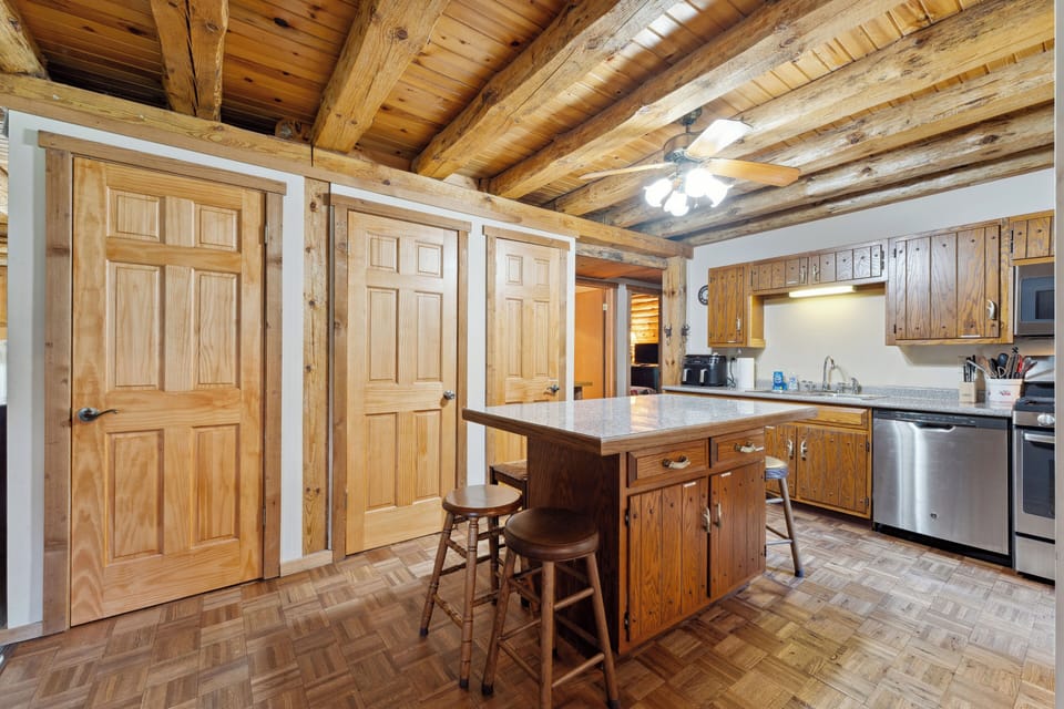 The lodge kitchen has a microwave, dishwasher, stove, fridge, Keurig