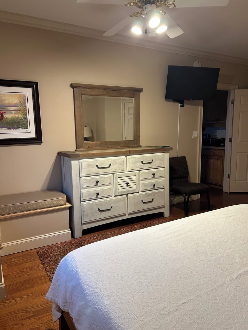 There is a lot of storage for clothing and a bench for sitting or luggage. 