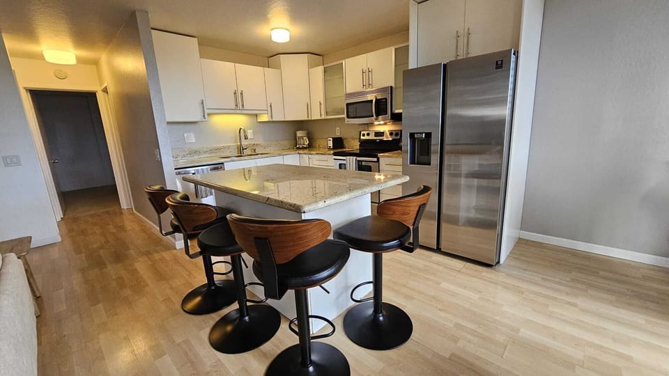 Kitchen with filtered water/ice maker, microwave, bar stools