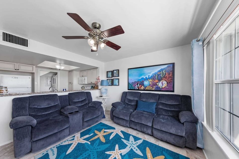 Open living space with a smart TV and vaulted ceiling