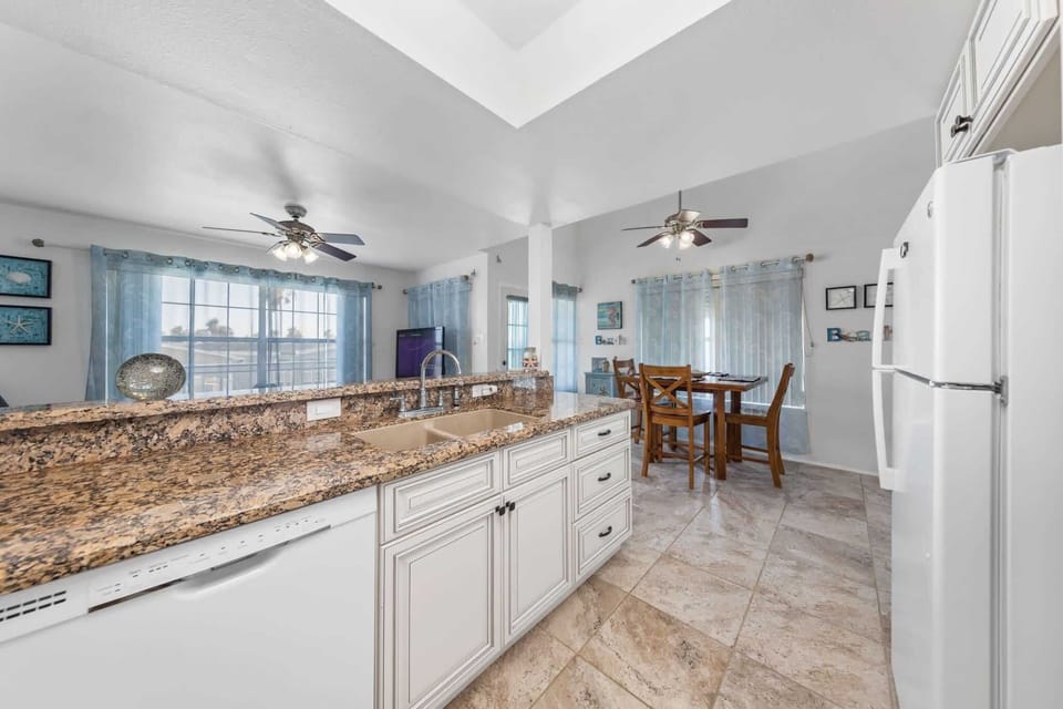 White cabinetry and full-size appliances make meals easy