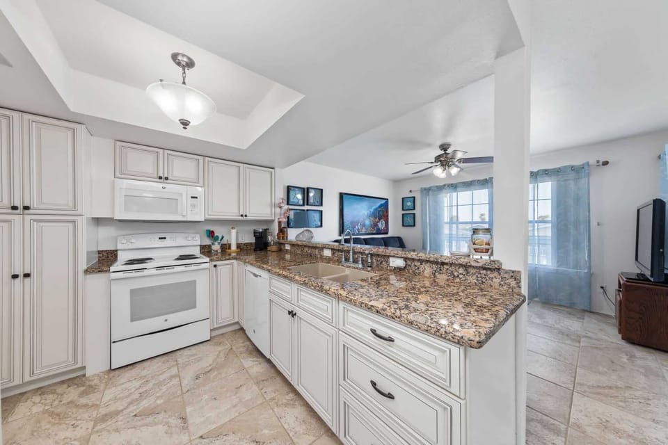 Cook in the full kitchen with granite counters and a breakfast bar