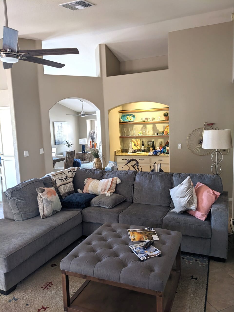Living area with large TV next to open dining room and reading area.