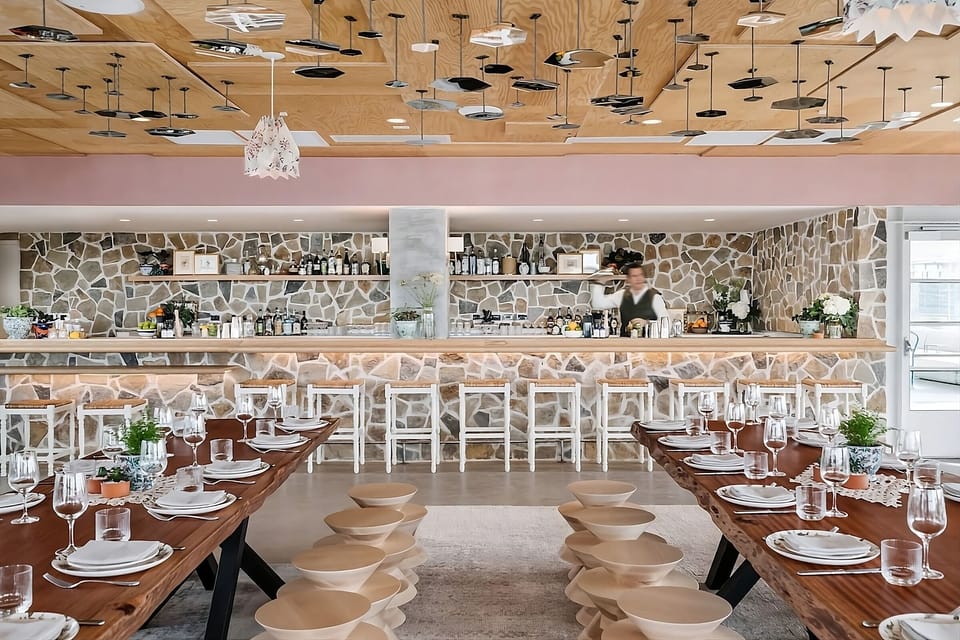 Celebrate together around rustic tables in a design-forward dining room