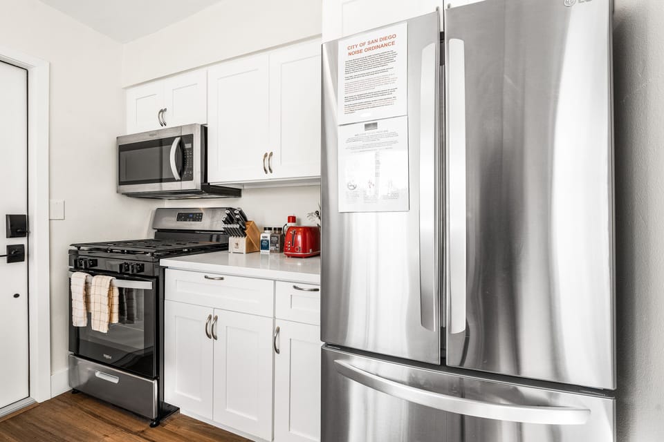 fully equipped kitchen with stainless steel appliances. 