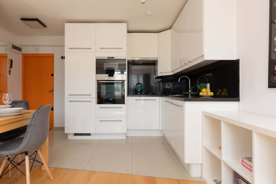 A wide-angle shot of the open-plan kitchen and dining area, showcasing the seamless and modern design.

