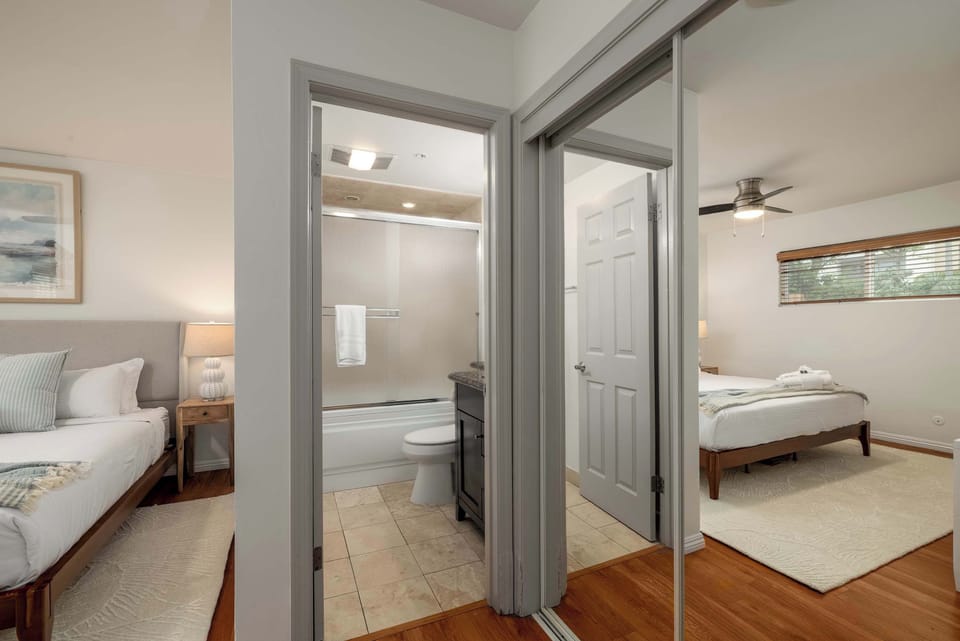 bedroom 1 (king bed, AC, ceiling fan, TV, clothing storage, attached bathroom)