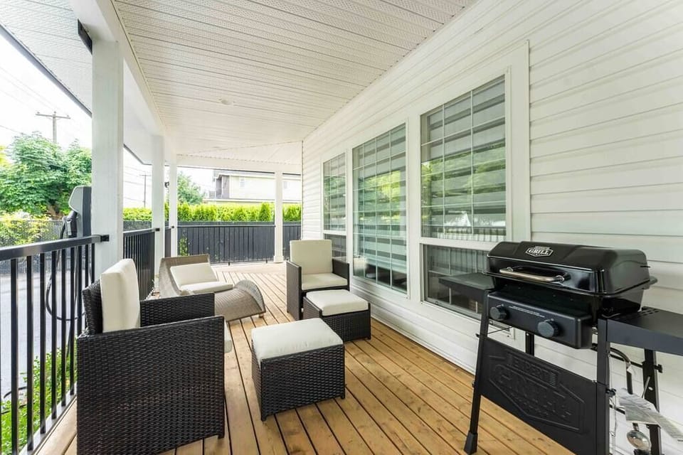 The covered patio's charming seating area is perfect for relaxing and unwinding.
