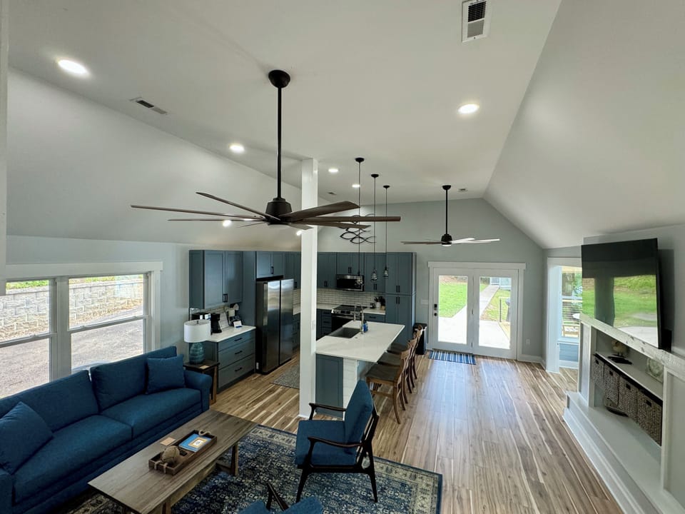 Living room with queen sleeper sofa and large smartTV