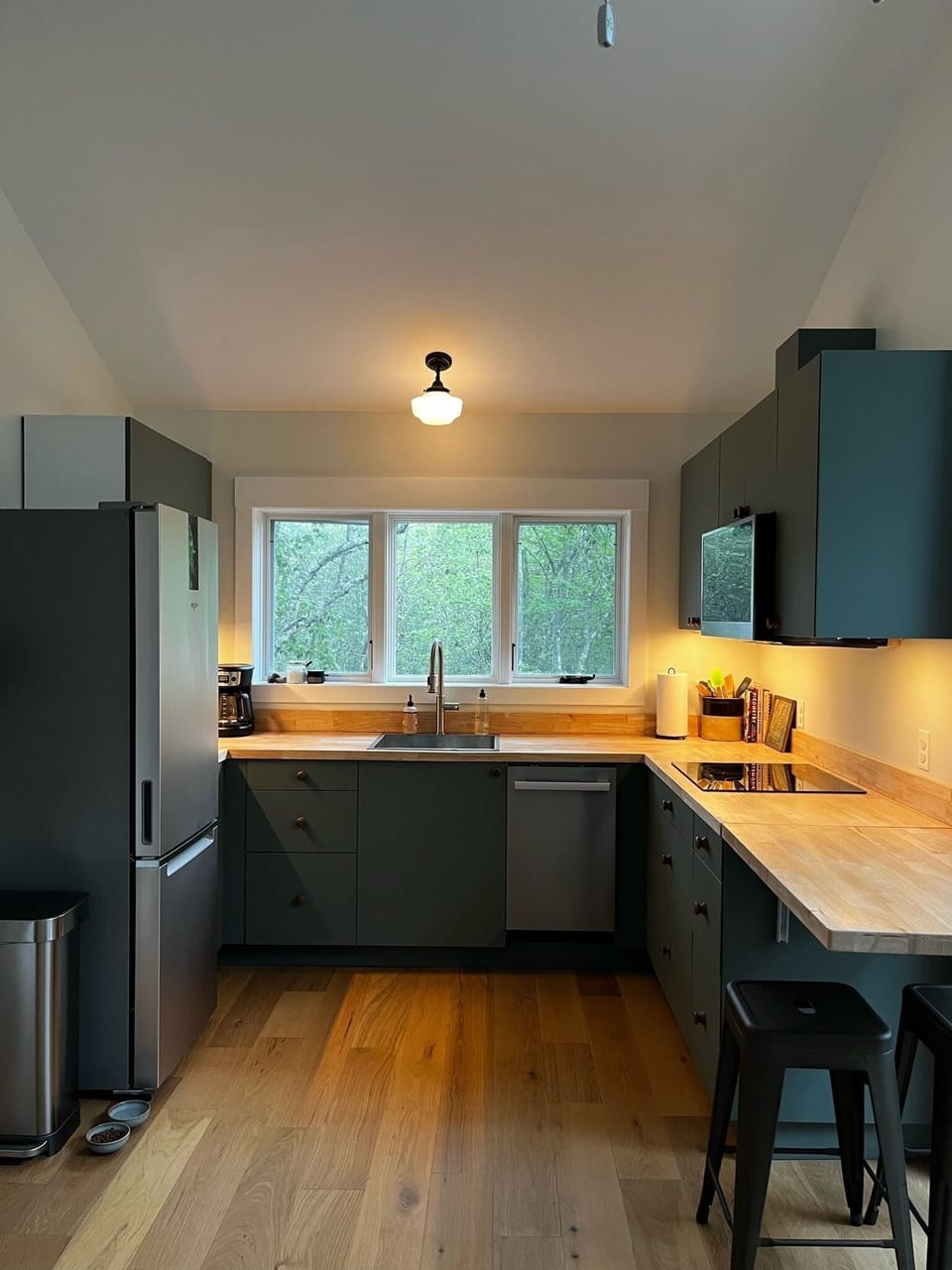 Kitchen w/ dishwasher, convection oven, fridge, convection cook top and seating.