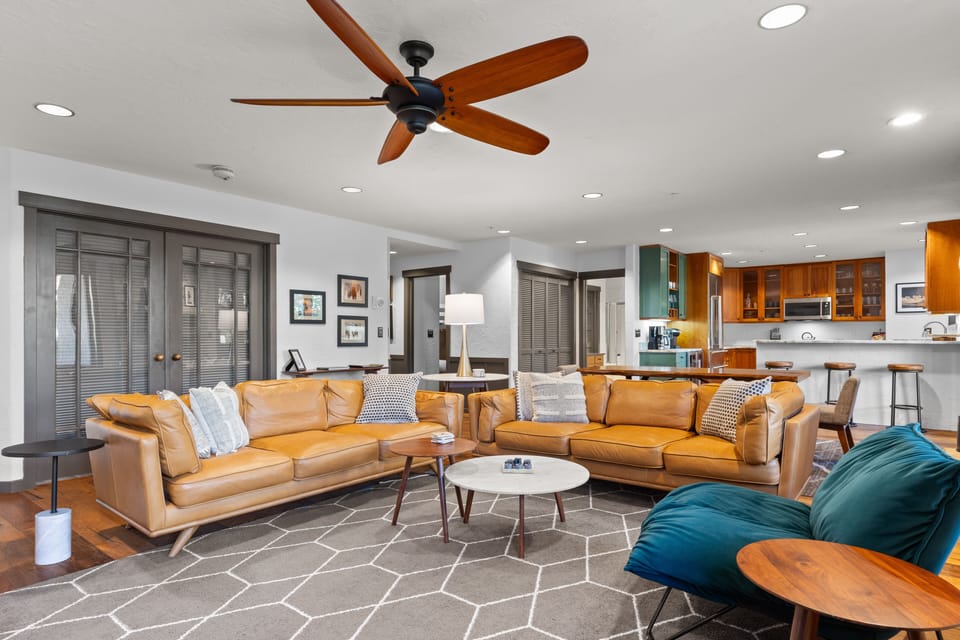 Spacious living room with two leather couches, all new furniture