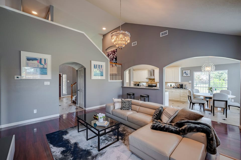 Living room with comfortable leather sofa and big screen TV with Netflix ready