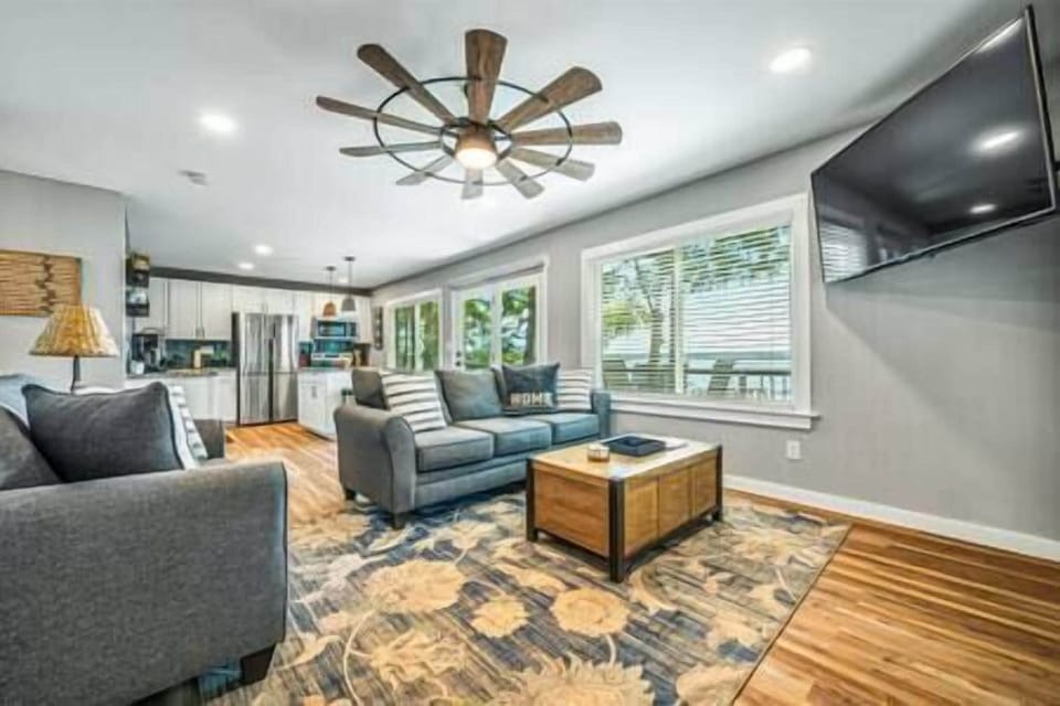 Open living room with big TV and views.