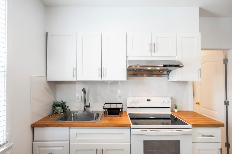 Kitchen equipped with basic dishware and utensils
