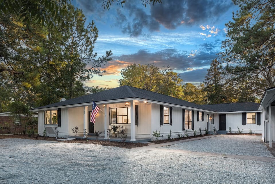 Apartment door seen on right side of home and apartment is on back side of home.