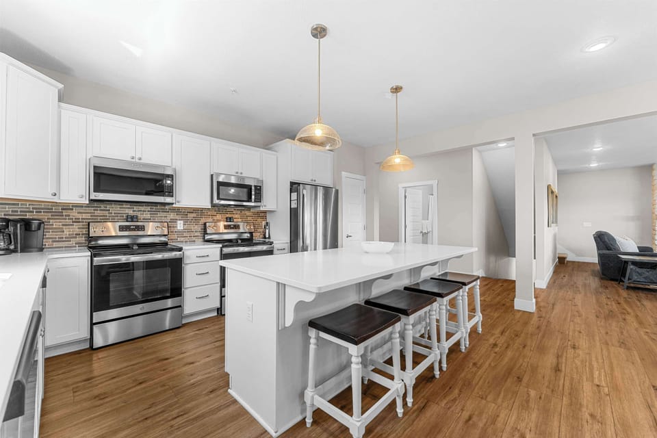 This kitchen has stainless steel appliances and cabinets fully stocked with all the cookware you need!
