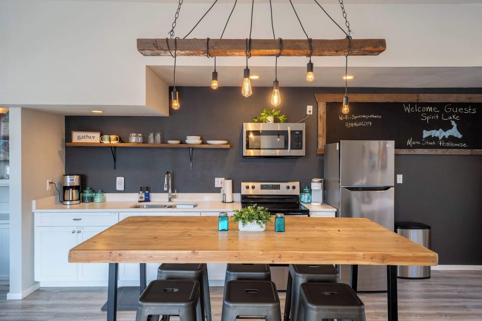 Fully stocked kitchen + woodsy dining space for home-cooked meals.