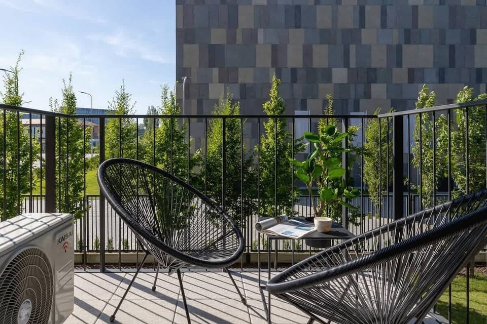 A closer look at the balcony décor—woven chairs, leafy plants, and a serene spot to relax outdoors.
