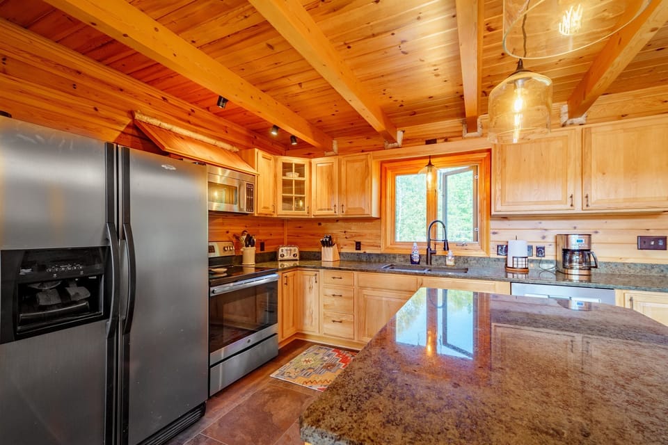 A large kitchen island and counter are convenient for preparing meals for your whole group