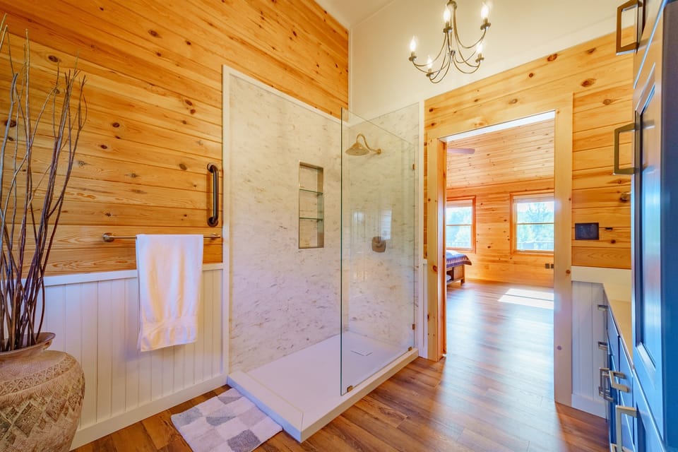 Luxuriate in our master ensuite bathroom with its 60" European walk-in shower, custom wood cabinetry, on-trend lighting and barn door leading to the bedroom