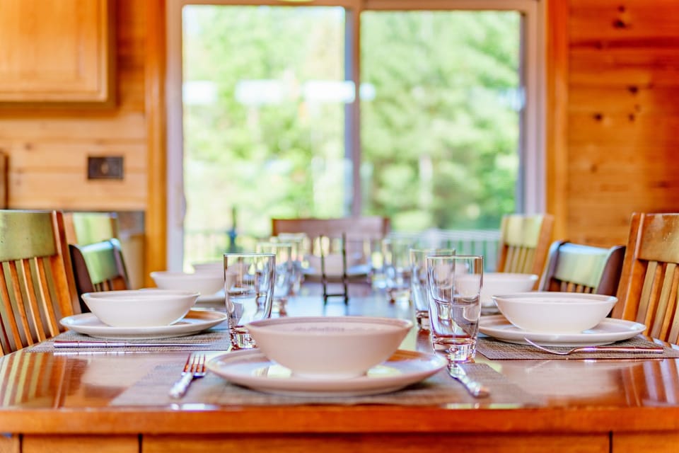 Prepare and enjoy great meals together in our open-plan kitchen, dining, and living area. The kitchen is fully stocked with dishware, cookware, utensils and appliances to make meals at home