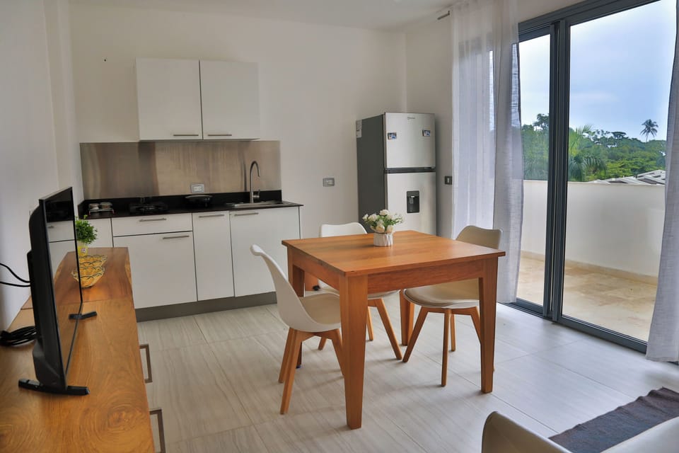 Breakfast area to kitchen with balcony view.