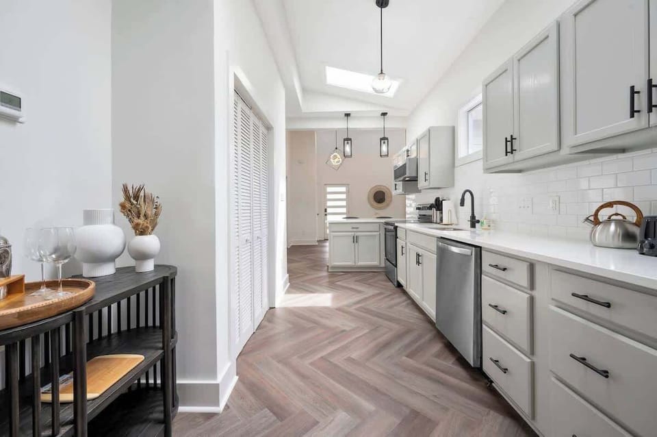 Enjoy culinary freedom in our fully stocked, open-concept kitchen. A spacious island with comfortable stools invites conversation as meals come to life, blending style and function for memorable shared moments.