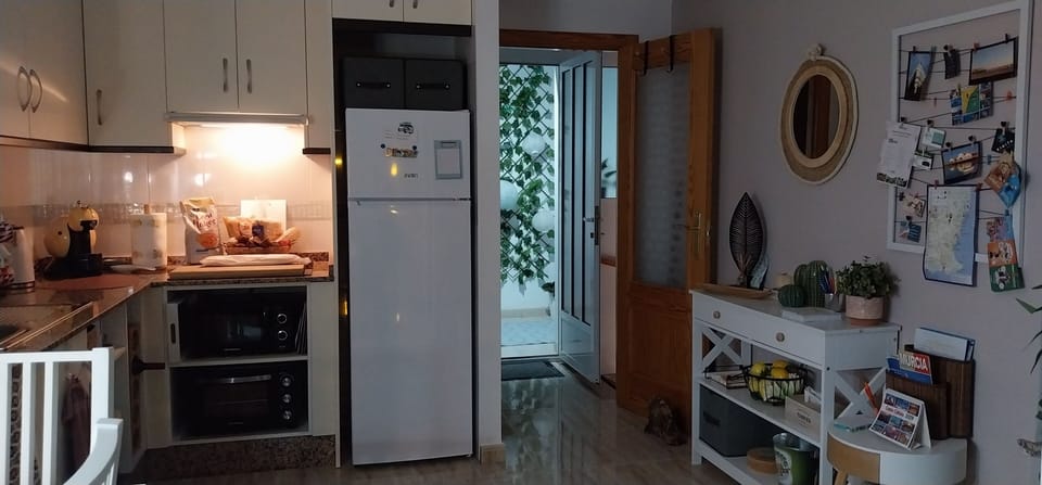 kitchen area leading out to rear courtyard and laundry facilities.  