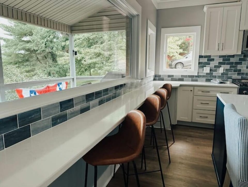 Lake view seating with power outlets under countertop.
