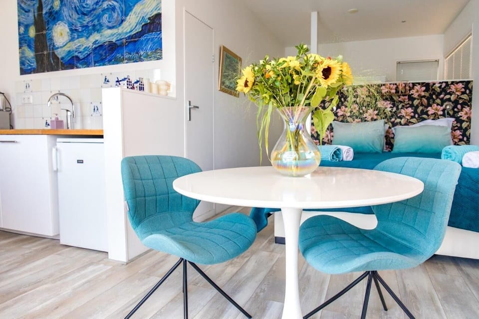 View of the bed, breakfast table and front door.