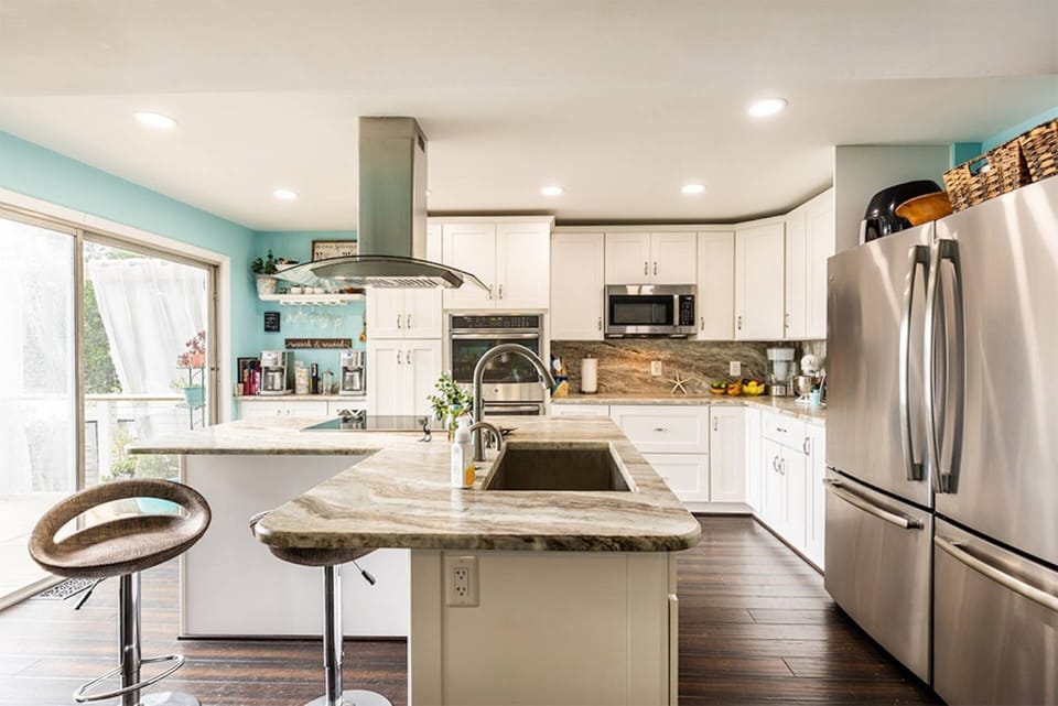 The kitchen has all of the appliances (small and large) to cook a family meal.