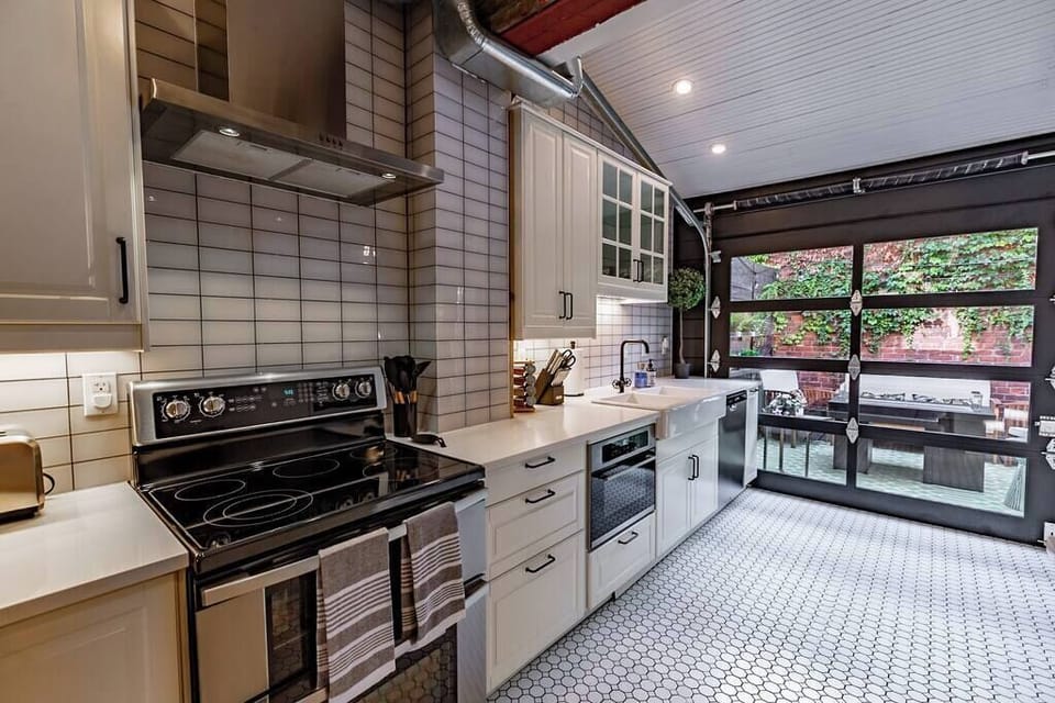 Unleash your culinary skills in our elegant and spacious kitchen, with direct access to the fire pit patio—where sophistication meets functionality for a delightful cooking and dining experience.