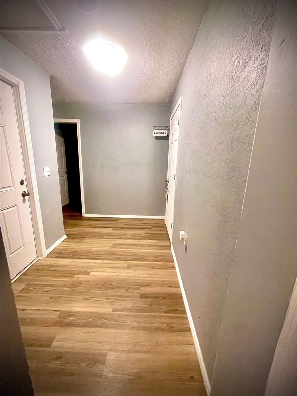 Hallway going to the master bedroom and rhe laundry room 