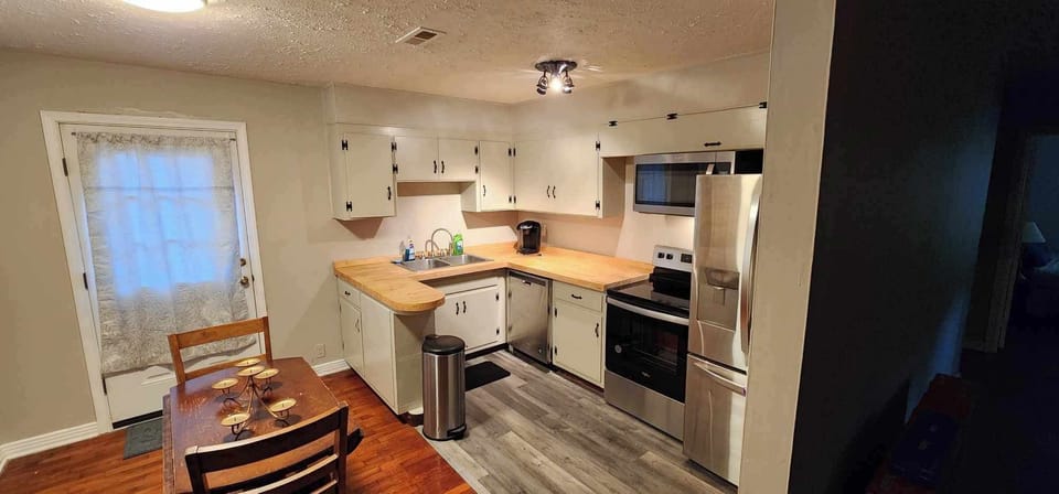 Dinning area and back deck door. Laundry to left and kitchen to right. 