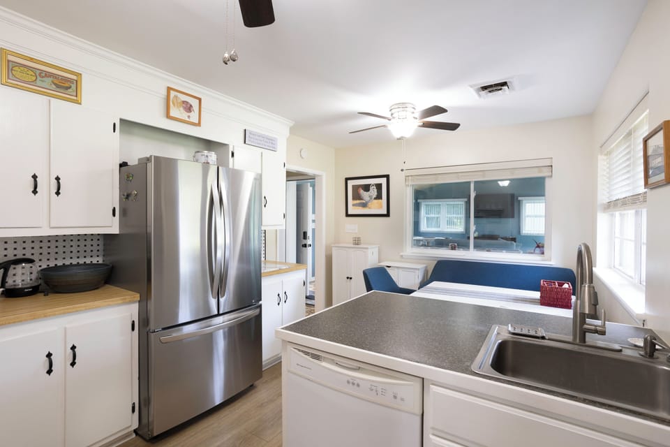 Eat in Kitchen has plenty of countertop space and a sliding window into sunroom
