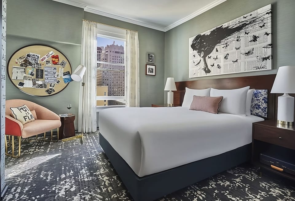 Sink into a serene king bed with sunny city views.